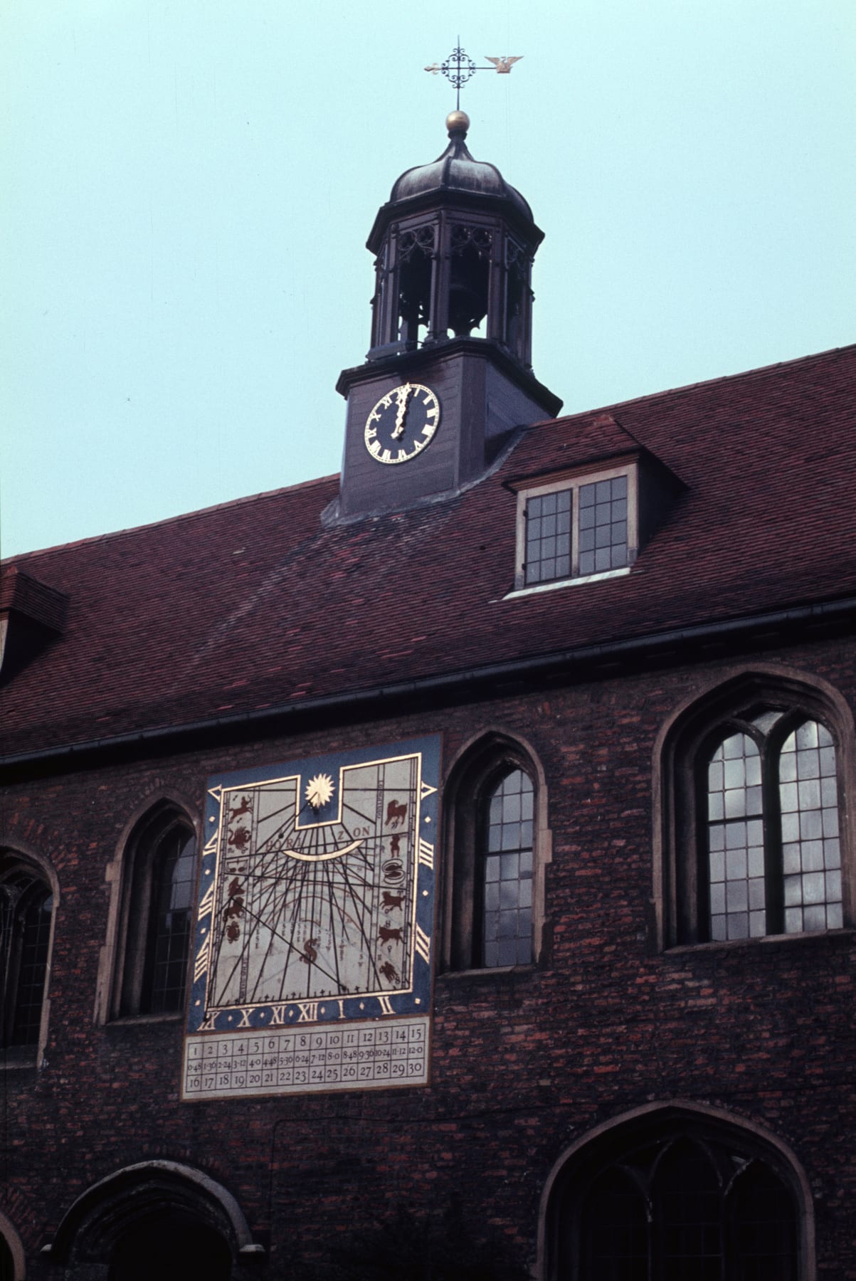 A richly decorated sundial and moondial painted on the wall of Old Court at Queens' College, Cambridge.